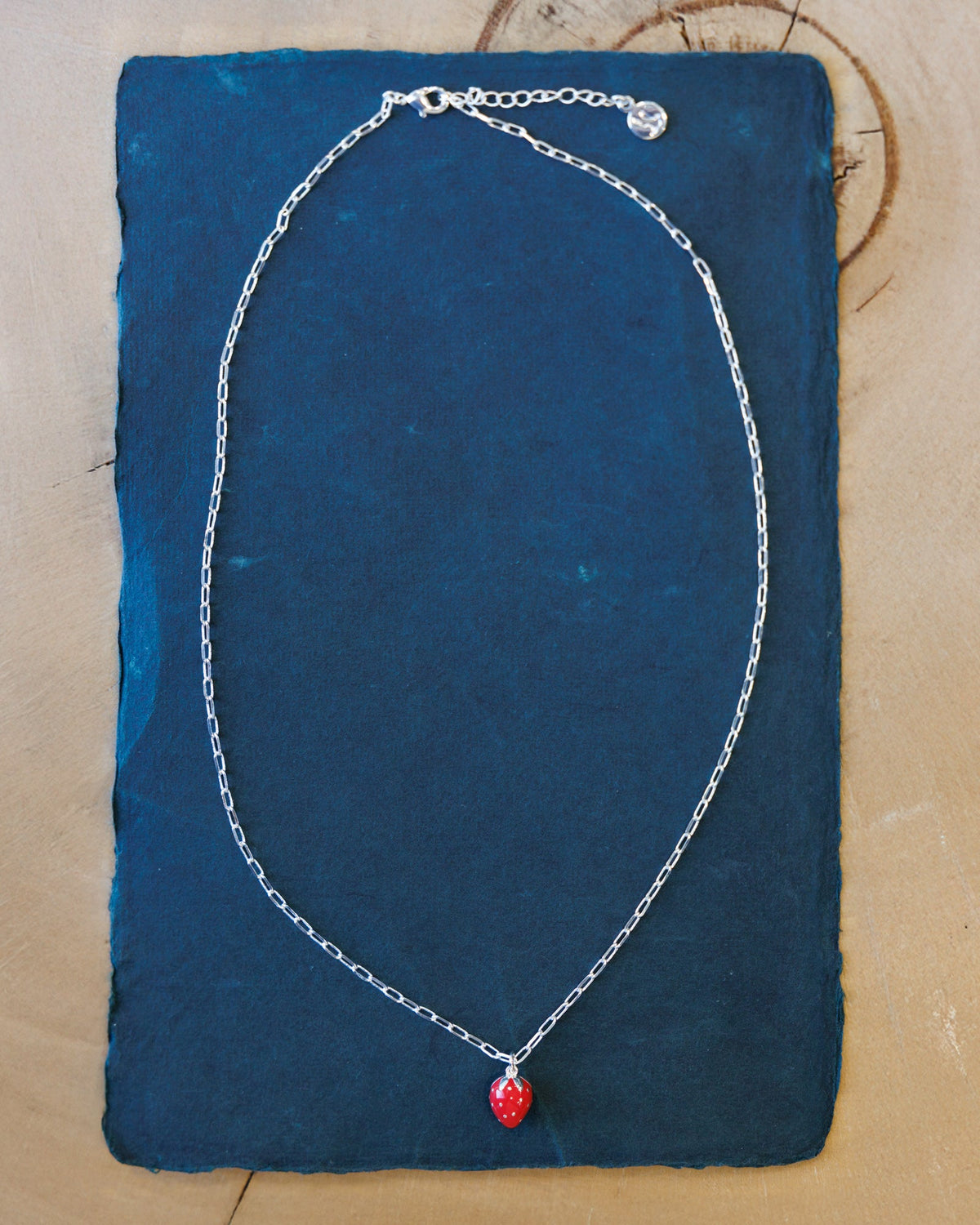 Silver Strawberry Fields Forever necklace by Downeast featuring a delicate strawberry pendant on a silver chain.