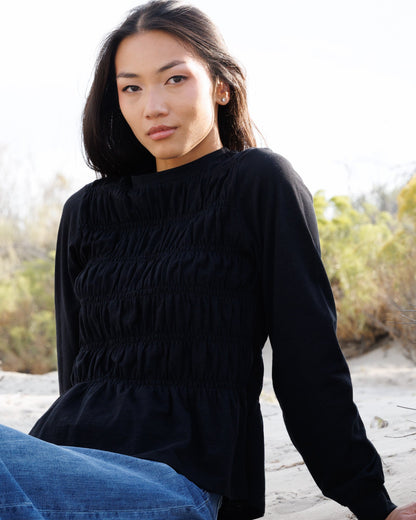 Downeast long sleeve smocked tee top with a relaxed fit and gathered neckline, shown on a model.