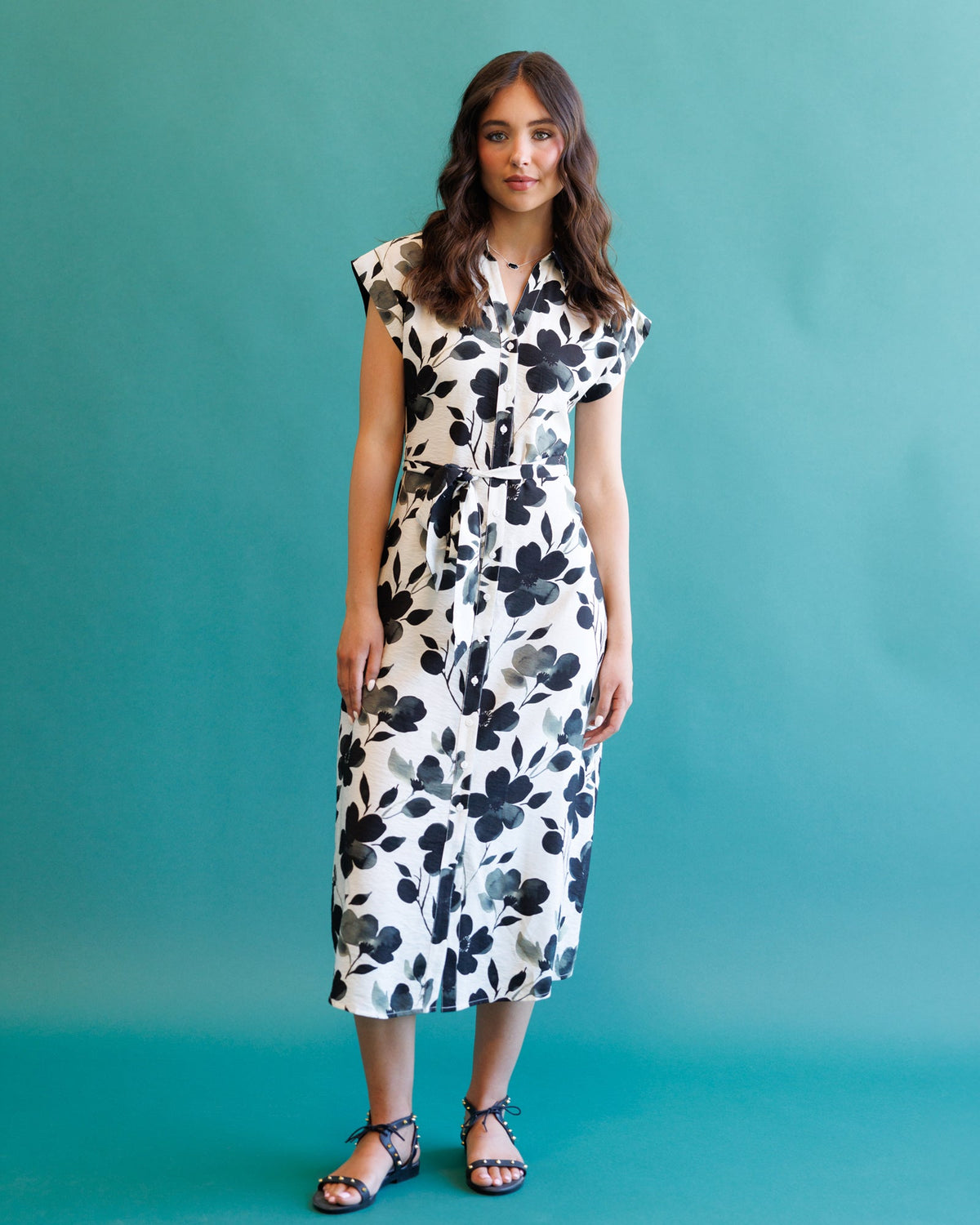 Downeast Quintessential Dress displayed on a hanger, showcasing its elegant fabric and classic style suitable for various occasions.