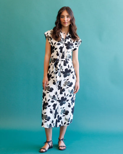 Downeast Quintessential Dress displayed on a hanger, showcasing its elegant fabric and classic style suitable for various occasions.
