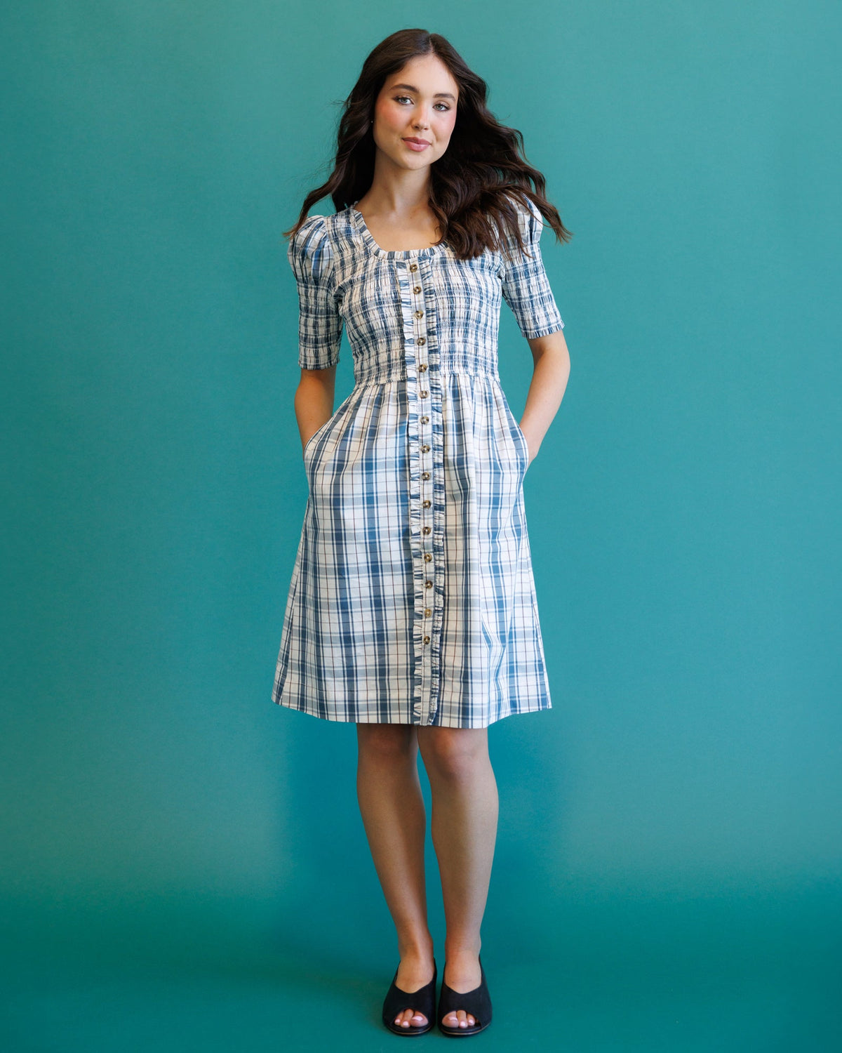 Downeast Oxford dress shown on a model, featuring a classic button-up design with a fitted waist and long sleeves.