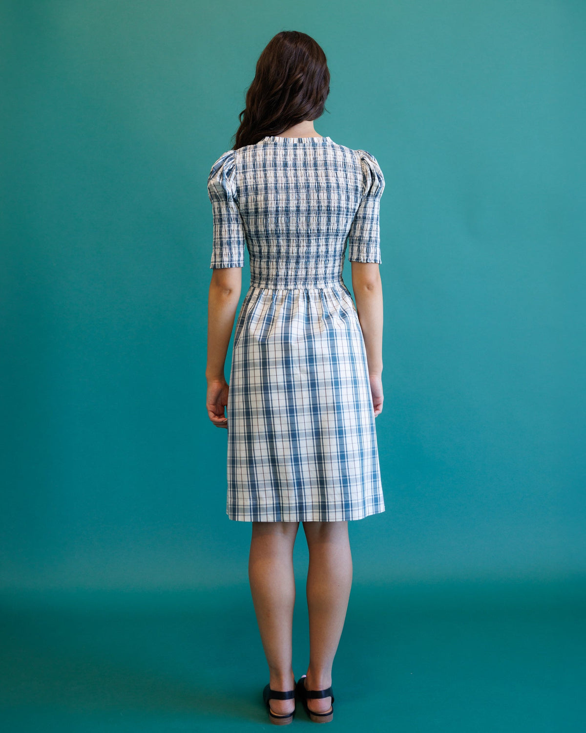 Downeast Oxford dress displayed on a hanger, featuring a classic button-up design with a collar and long sleeves.