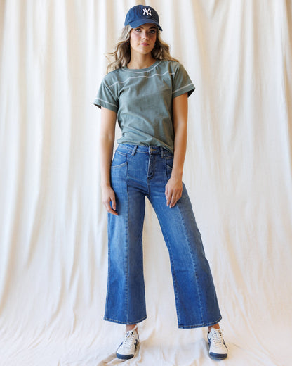 Downeast high rise seamed wide-leg denim ankle jeans displayed on a hanger with visible stitching and a classic blue wash.