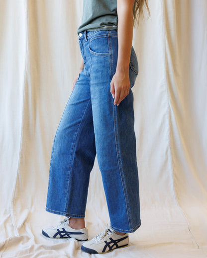 Downeast high rise seamed wide leg ankle denim jeans shown on a model, featuring a classic blue wash and modern fit.