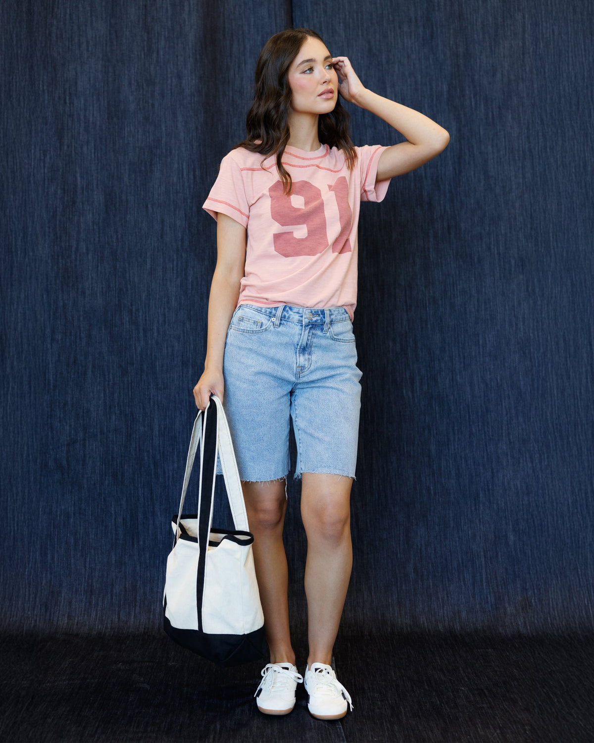 Downeast cheer section tee shirt, casual top with team spirit design, lightweight fabric, worn by a person in a sporty setting