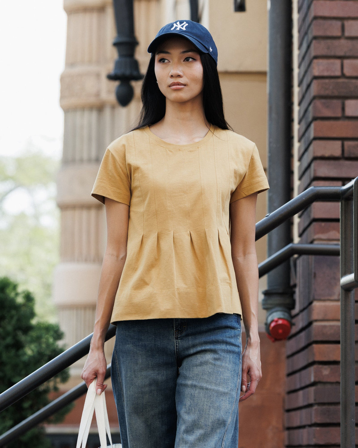 Downeast Portland peplum top in soft fabric with short sleeves and a fitted waist, styled on a hanger.