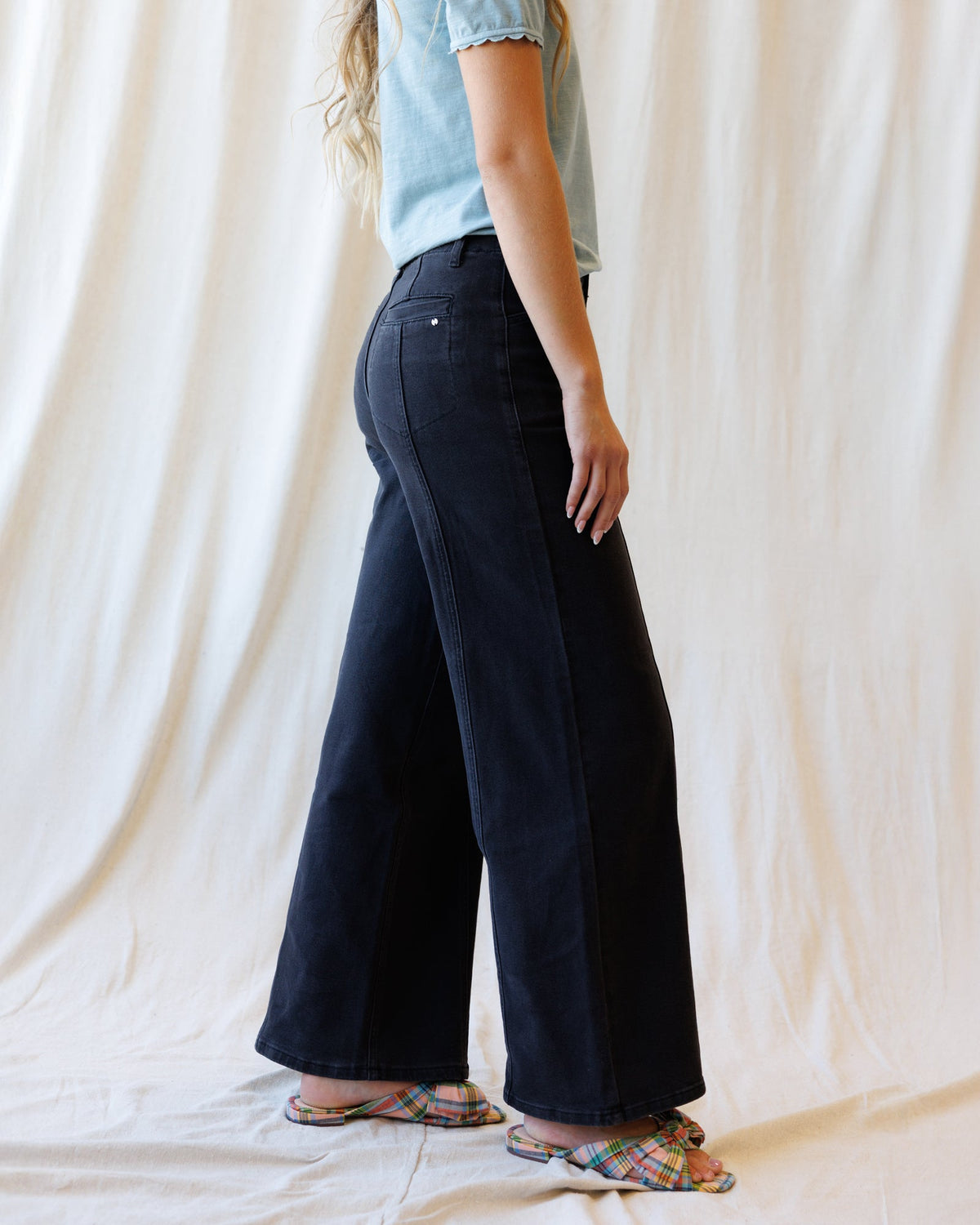 Downeast high rise seamed denim trousers shown on a model, featuring a classic fit and stylish seaming details.