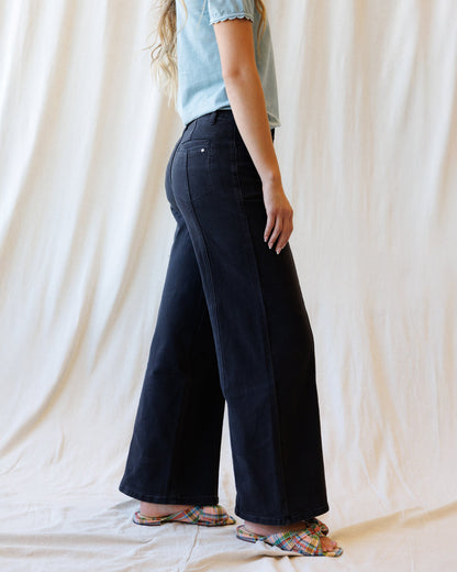Downeast high rise seamed denim trousers shown on a model, featuring a classic fit and stylish seaming details.