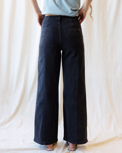 Downeast high rise seamed denim trousers with front and back pockets, fitted waistband, and classic blue jean styling.
