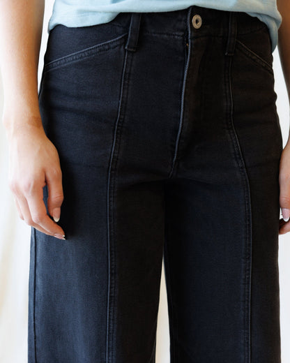 Downeast high rise seamed denim trousers with front and back stitching, styled on a model for a casual, fashionable look.