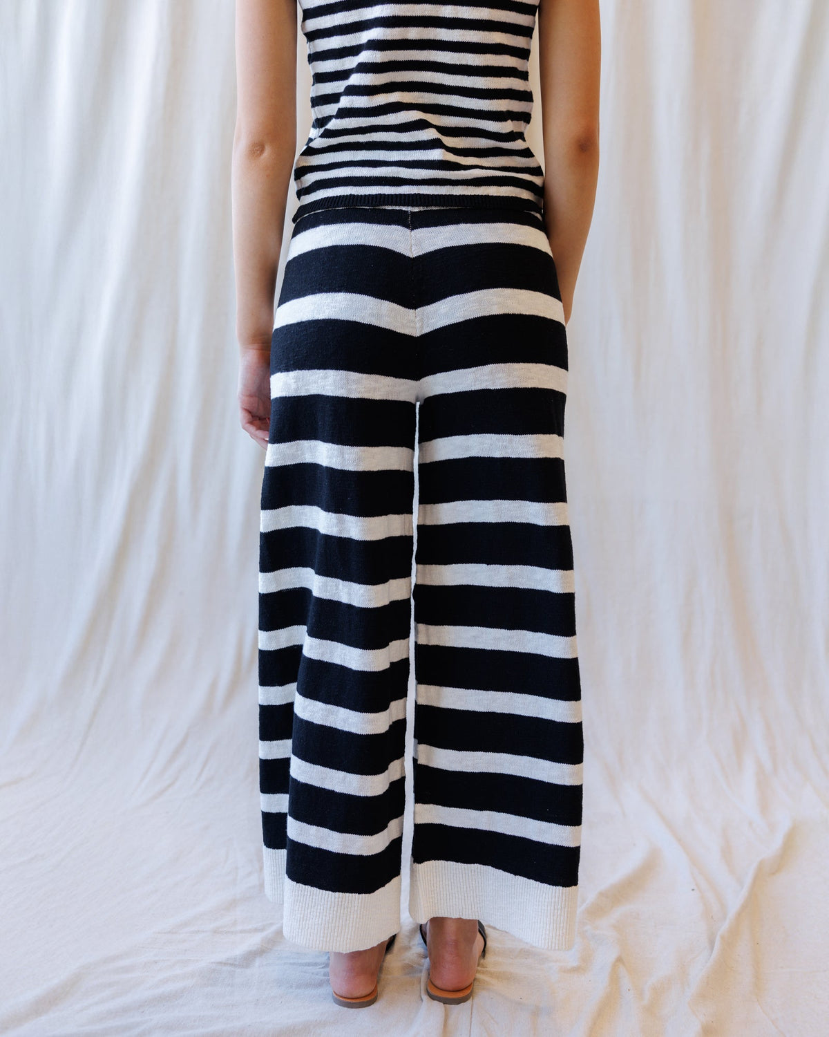 Downeast Round Trip Pants, stylish casual pants in a neutral color, displayed on a hanger with a focus on the fabric texture.