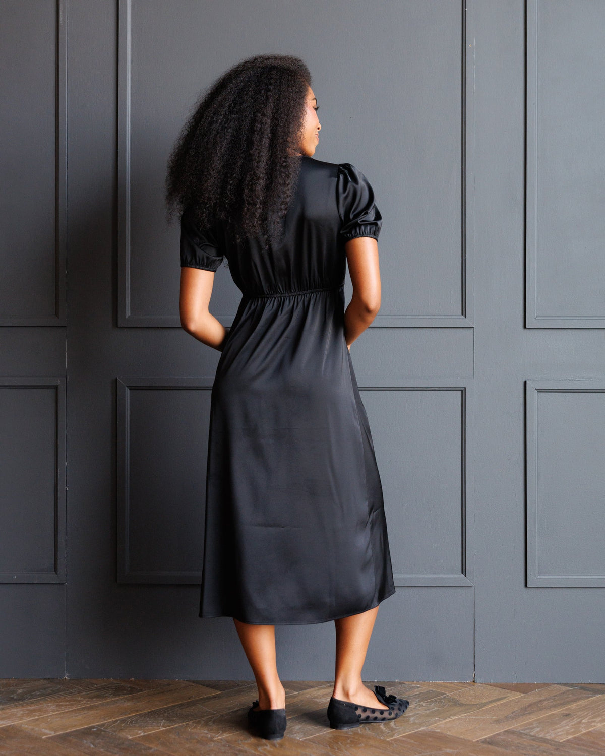 Downeast First Love Dress, elegant sleeveless dress with floral pattern and V-neck, displayed on a hanger.
