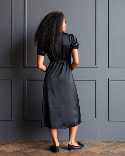 Downeast First Love Dress, elegant sleeveless dress with floral pattern and V-neck, displayed on a hanger.