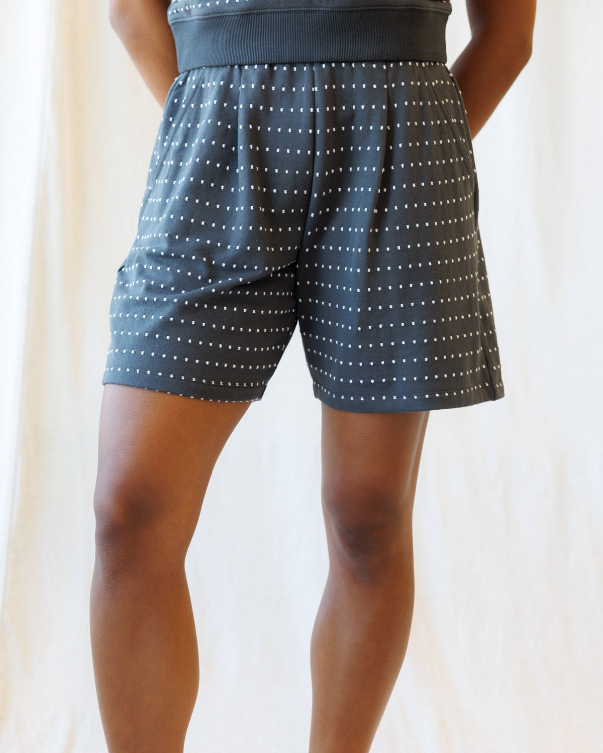 Downeast On Repeat Short in denim with rolled cuffs, front pockets, and relaxed fit, displayed flat for casual summer style.