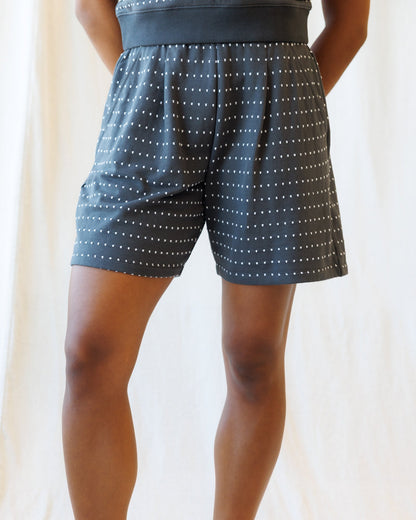 Downeast On Repeat Short in denim with rolled cuffs, front pockets, and relaxed fit, displayed flat for casual summer style.