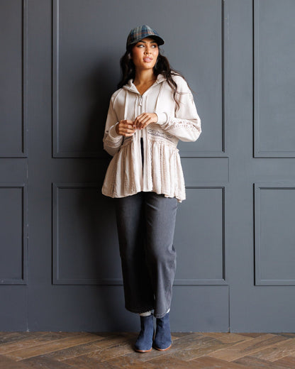 Downeast Hometown Hoodie, cozy outerwear with a front pocket and hood, displayed on a hanger against a neutral background.