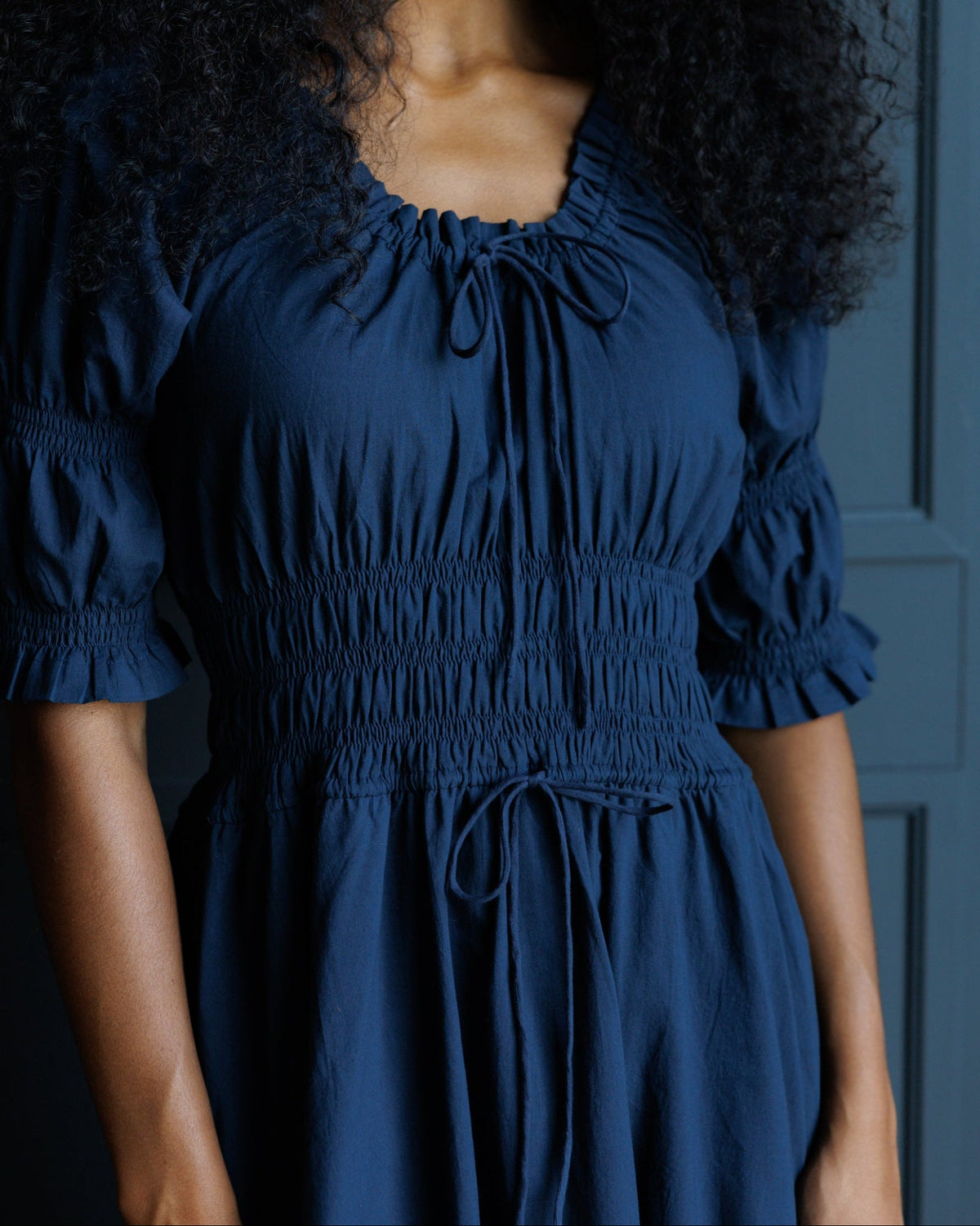 Downeast Long Way Home Dress in Blue Nights, showing a flowy, sleeveless dress with a relaxed fit and elegant neckline.
