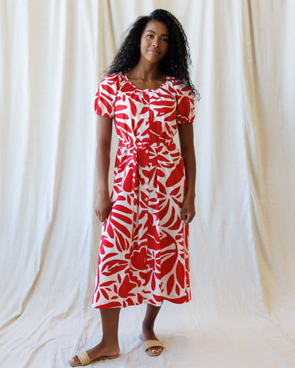 Downeast Vitamin Sea Dress hanging on a rack, featuring lightweight fabric, floral pattern, and sleeveless design for summer wear.