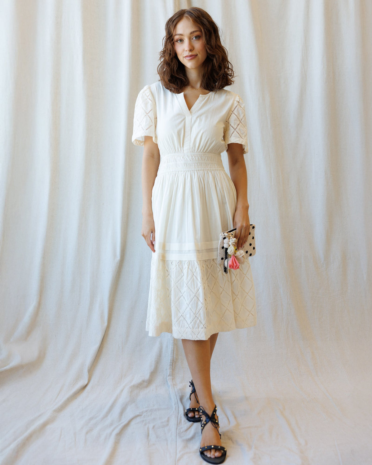 Downeast Icon Demi Lace Dress displayed on a hanger, showcasing intricate lace details and elegant design.