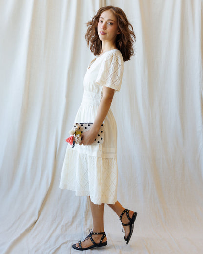 Downeast Icon Demi Lace Dress displayed on a hanger, featuring intricate lace details and a classic fit for elegant occasions.