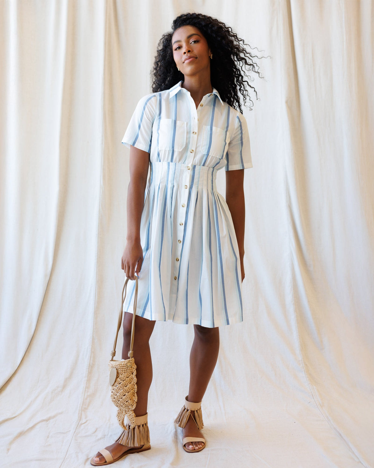 Downeast Seaside Stripe Dress featuring a blue and white striped pattern, sleeveless design, and flowy fabric perfect for summer.
