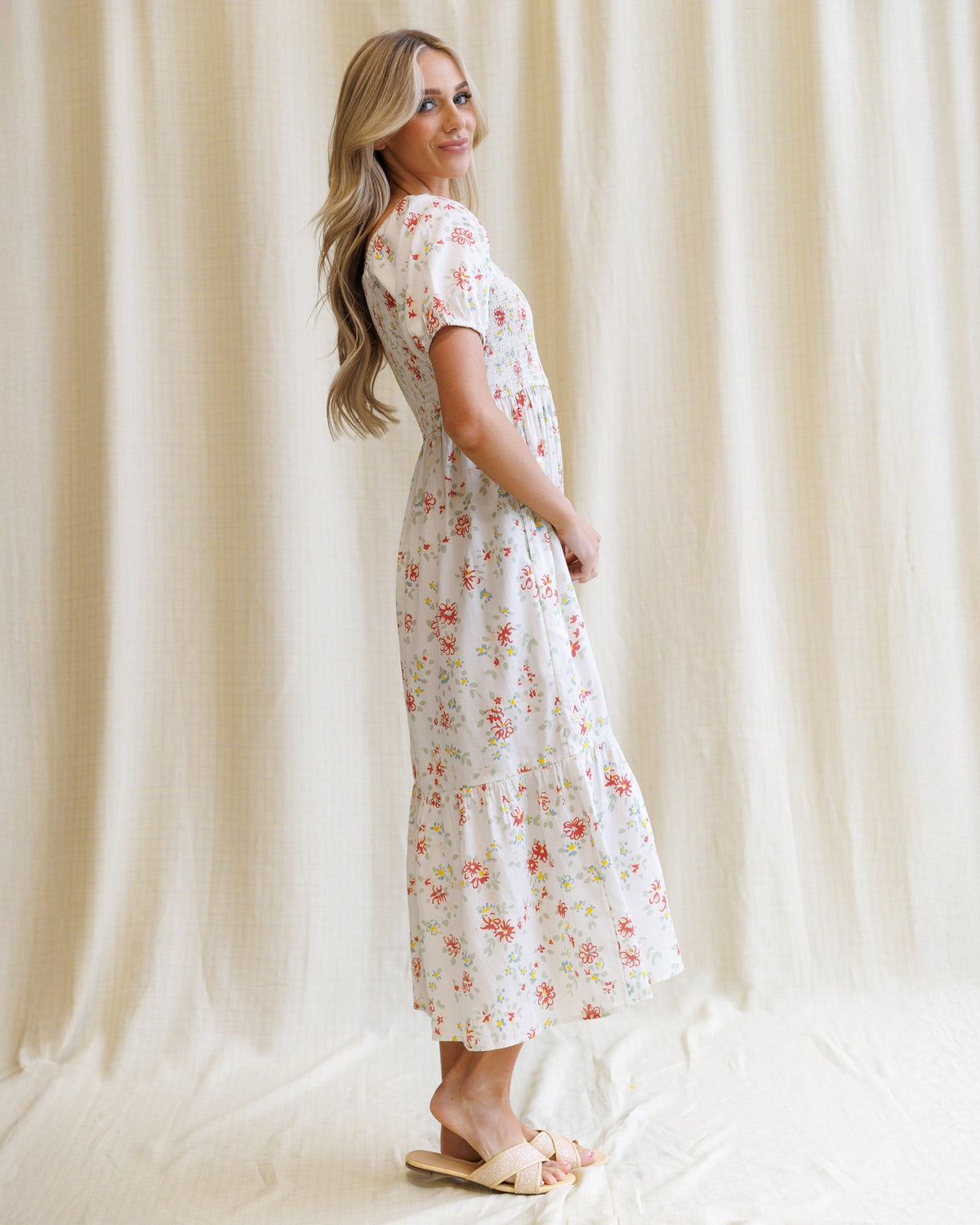 Downeast High Tea Dress showing a floral-patterned, elegant dress with a fitted waist and flowy skirt, perfect for formal occasions.