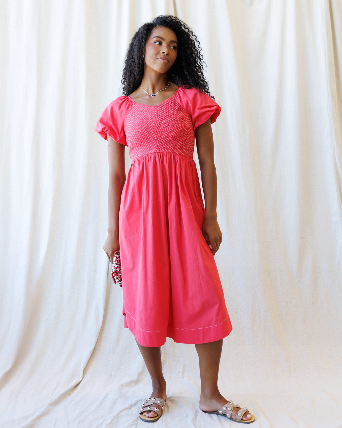 Downeast One Fine Day Dress hanging on a wooden hanger with floral pattern and lightweight fabric.