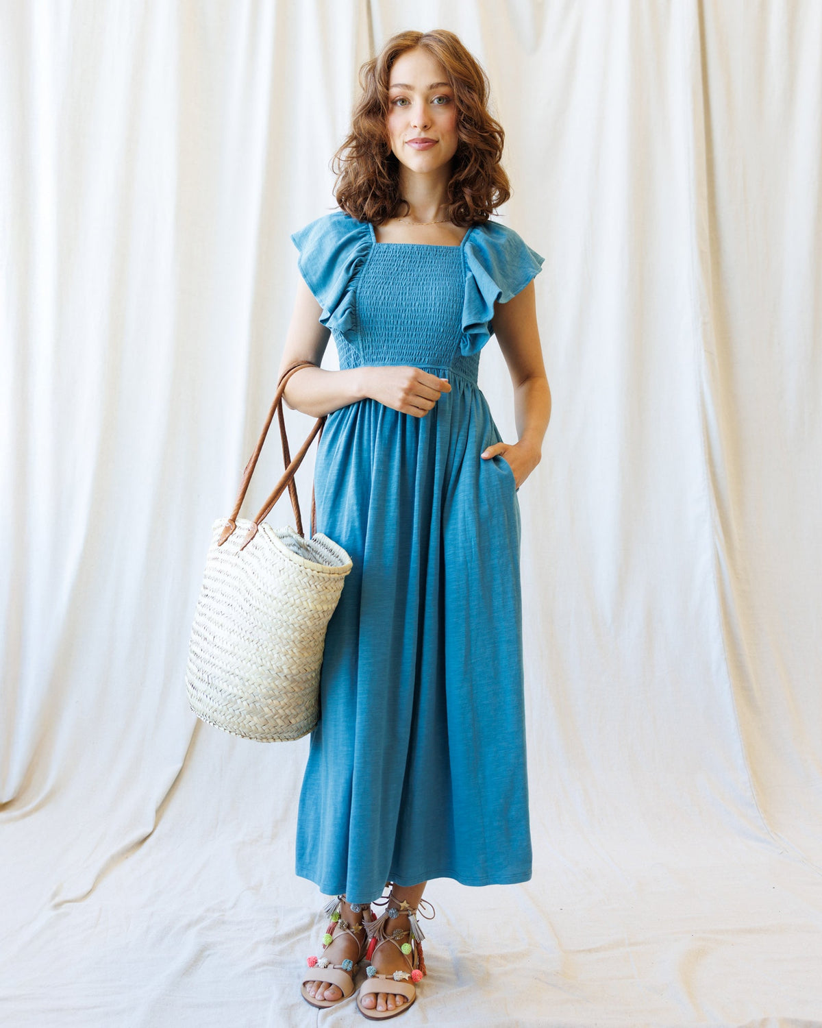 Downeast Sol Mate Dress shown in a stylish, flowy design with floral pattern and sleeveless cut, perfect for summer wear.
