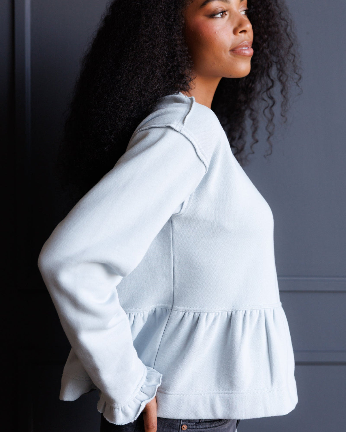 Downeast country peplum crew top featuring a fitted silhouette and classic design, shown in a neutral color.