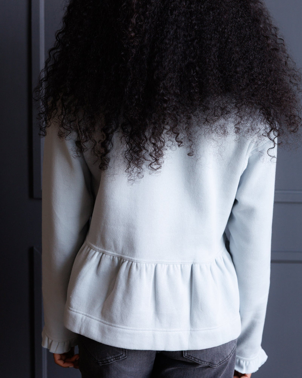 Downeast country peplum crew top featuring a fitted silhouette and casual style, shown in a natural fabric texture.