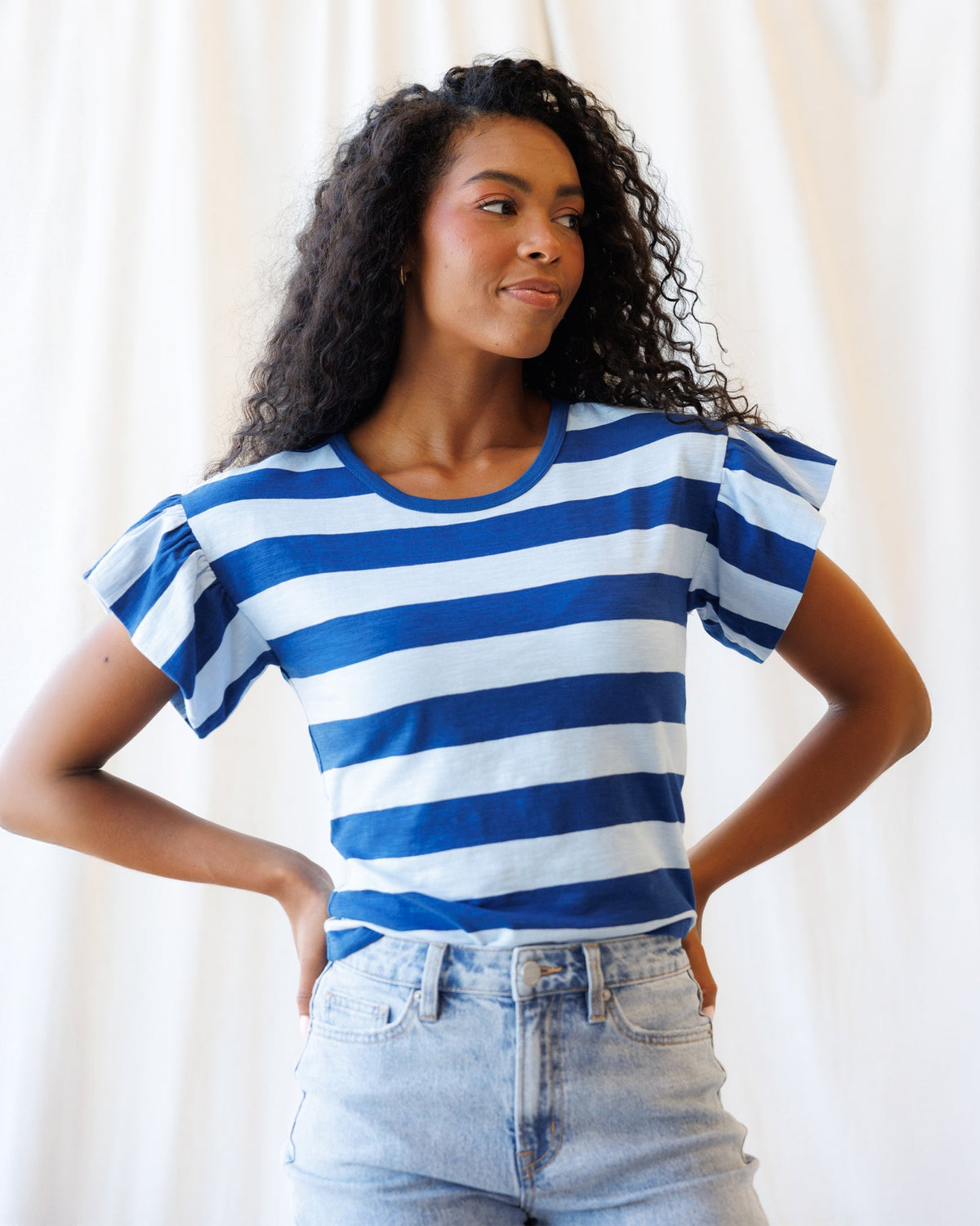 Downeast Charisma Tee, a casual tops with a comfortable fit, displayed on a hanger with a soft fabric texture.