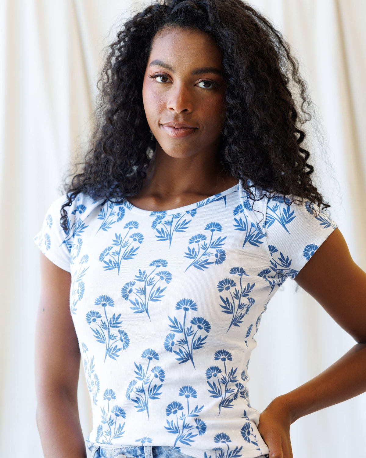 Downeast Artistic Tee, a casual tops style featuring colorful abstract print on soft fabric, displayed on a hanger.