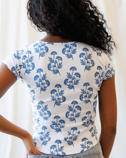 Downeast Artistic Tee, casual top with artistic design, featuring soft fabric and relaxed fit, displayed on a hanger.