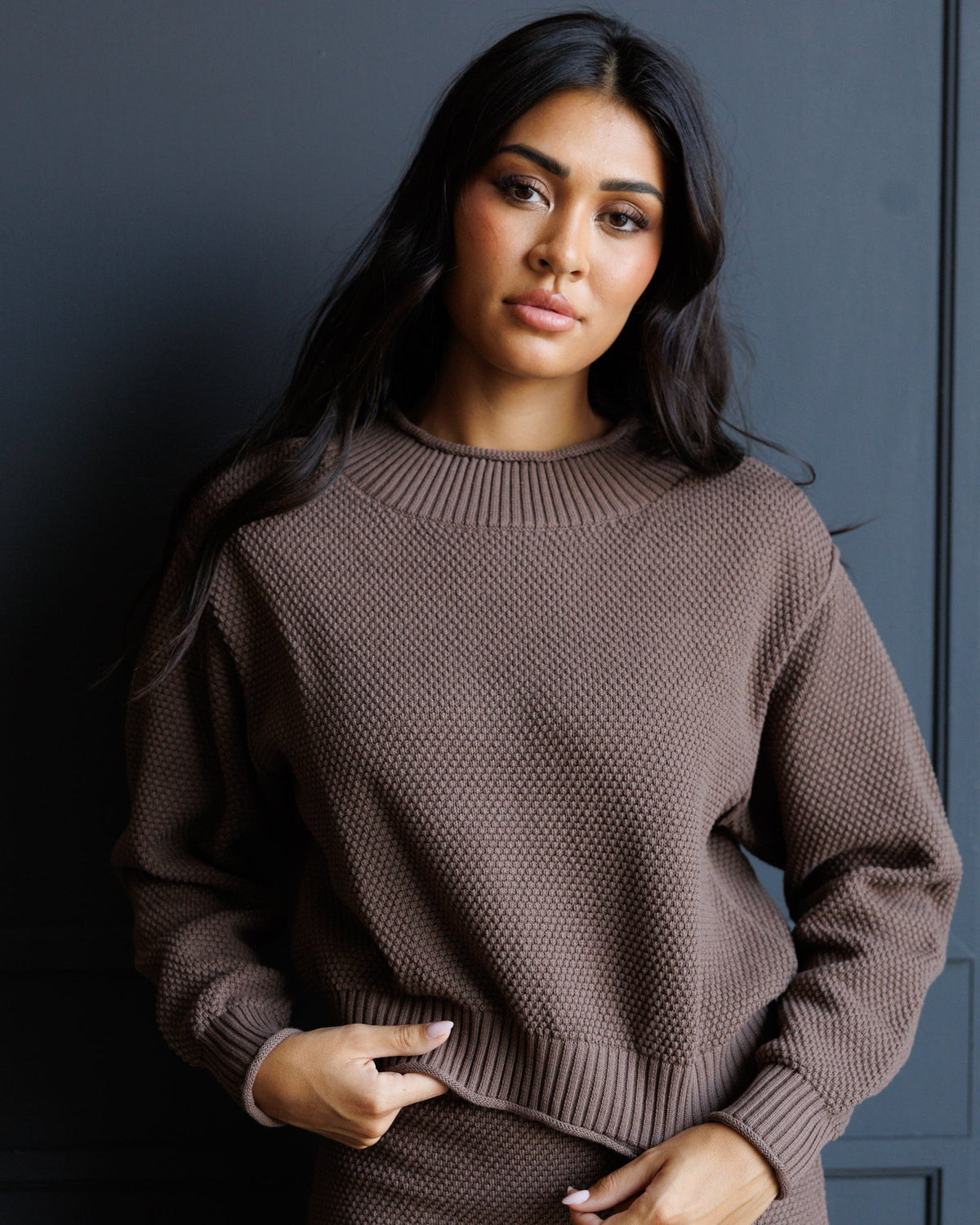 Downeast Carpe Diem sweater featuring a cozy knit fabric in a neutral color, displayed on a hanger.