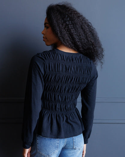 Downeast long sleeve smocked tee in soft fabric, featuring a fitted silhouette and gathered details at the sleeves.