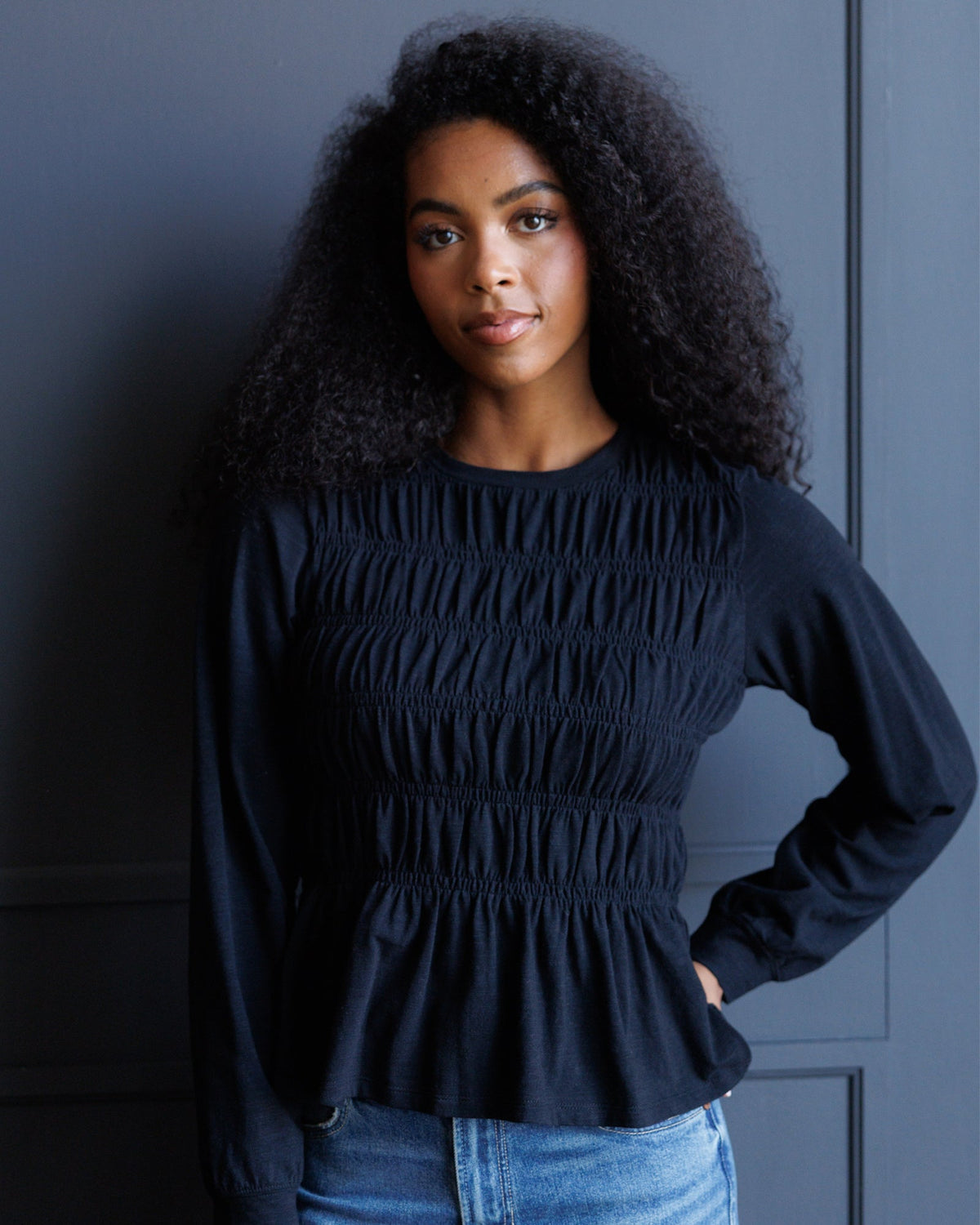 Downeast long sleeve smocked tee in soft fabric, featuring a fitted silhouette and gathered detailing at the neckline.
