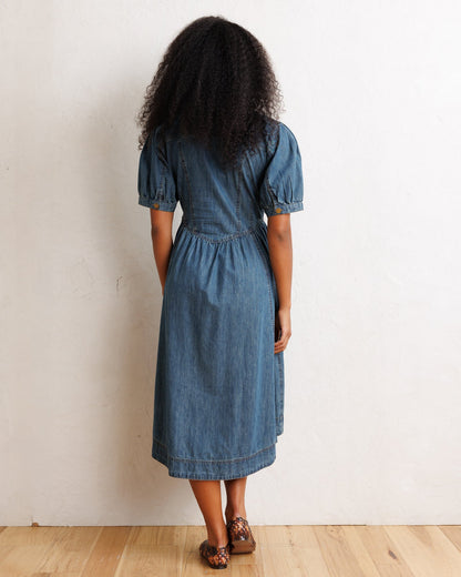 Downeast Orchard Denim Dress displayed on a hanger, showcasing its casual sleeveless design and classic denim fabric.
