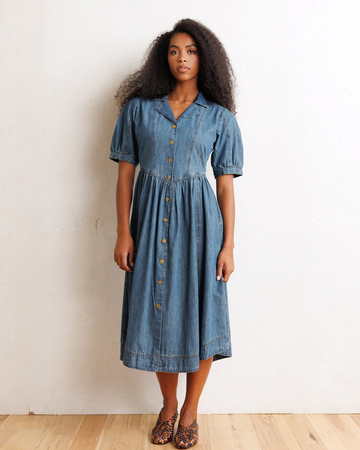 Downeast Orchard Denim Dress, casual sleeveless dress with button details and a fitted waist, displayed on a hanger.