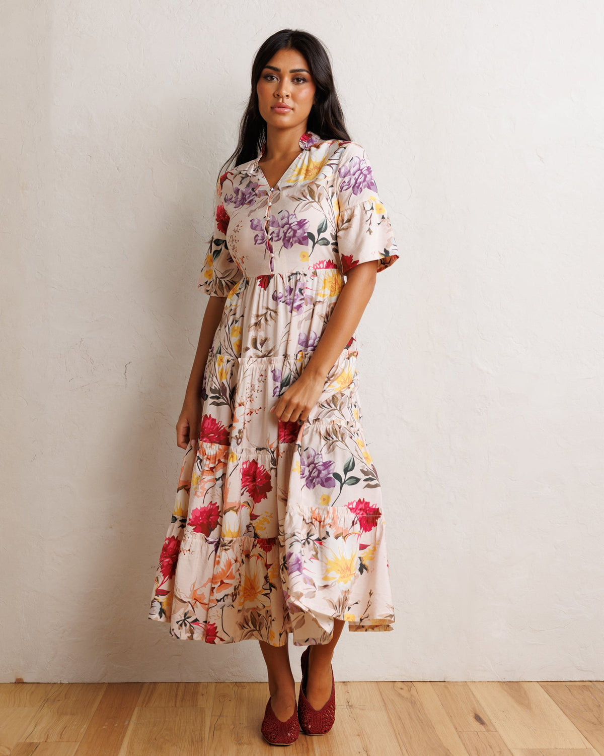 Downeast Mcintosh Maxi Dress with floral pattern, flowing fabric, and sleeveless design displayed on a hanger.
