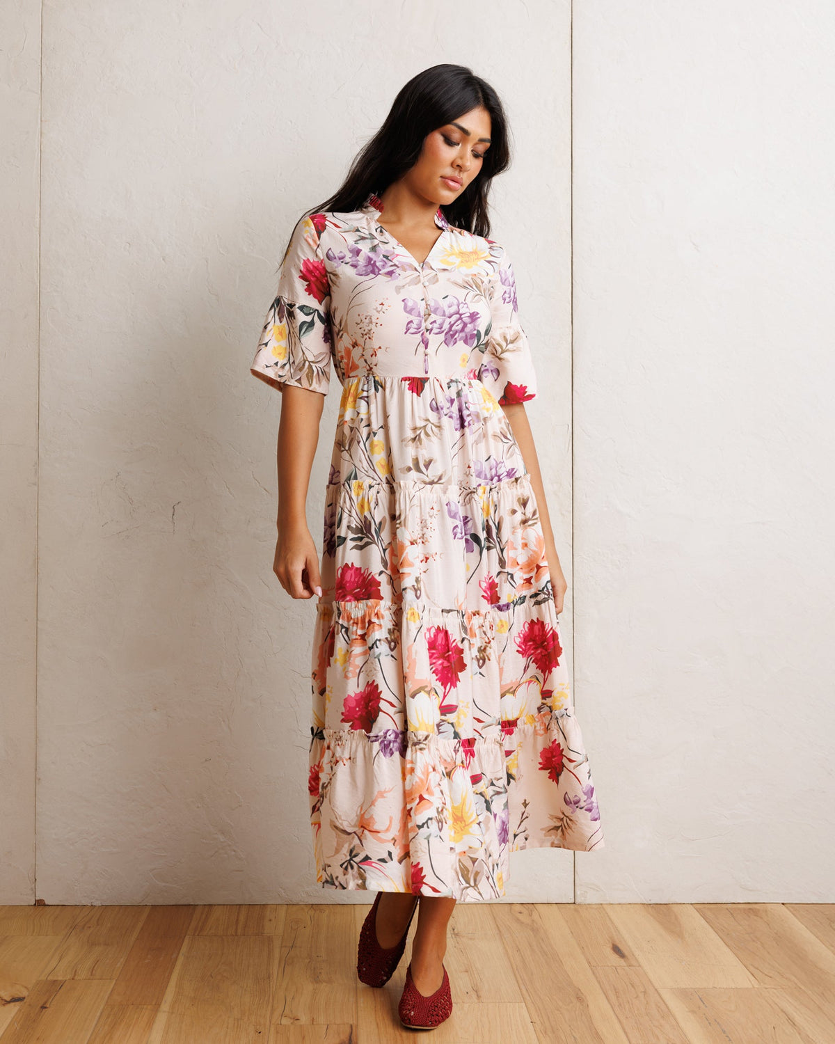 Downeast Mcintosh maxi dress featuring a flowing silhouette and floral pattern, displayed on a hanger against a white background.