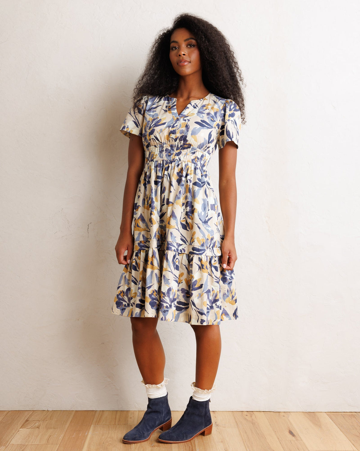 Downeast Icon Demi Dress displayed on a hanger, showcasing its elegant design and fabric details.