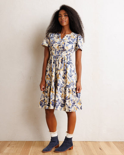 Downeast Icon Demi Dress displayed on a hanger, showcasing its elegant design and fabric details.