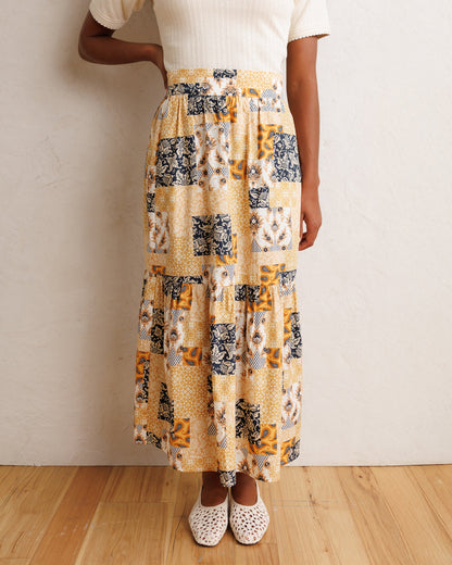 Downeast heirloom skirt with floral pattern, flowing fabric, and high waist, displayed on a hanger.