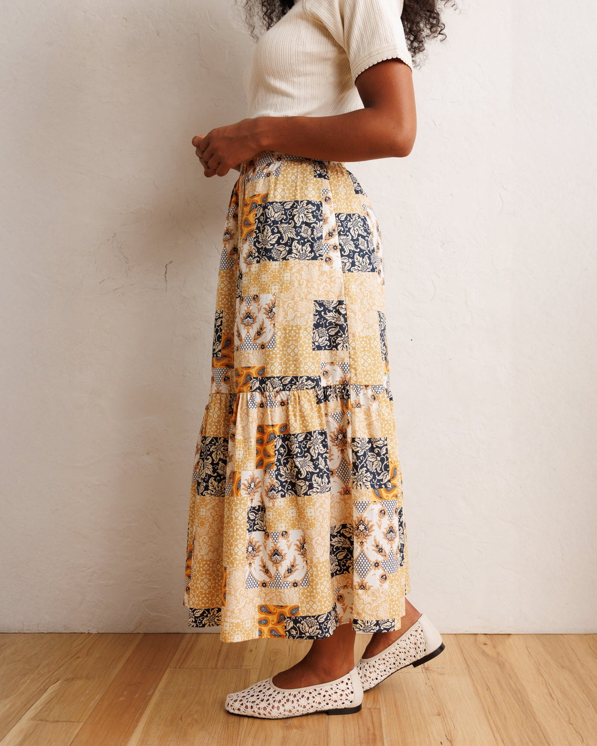 Downeast heirloom skirt with floral pattern, flowing fabric, and high waist, styled with a casual, vintage-inspired look.