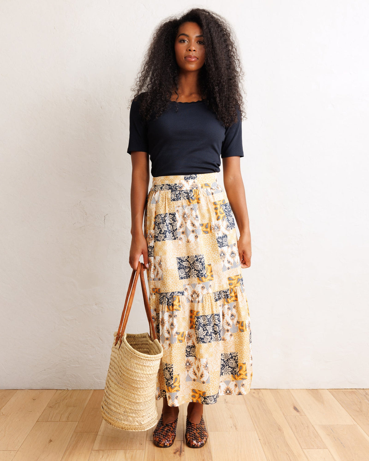 Downeast heirloom skirt with floral patterns and flowing fabric, displayed on a hanger against a neutral background.