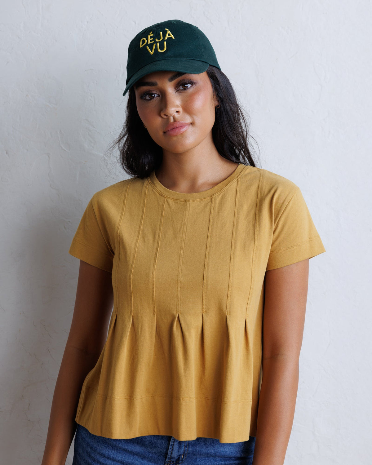 Downeast Portland Peplum Top in soft fabric with short sleeves and a fitted waist, displayed on a hanger.