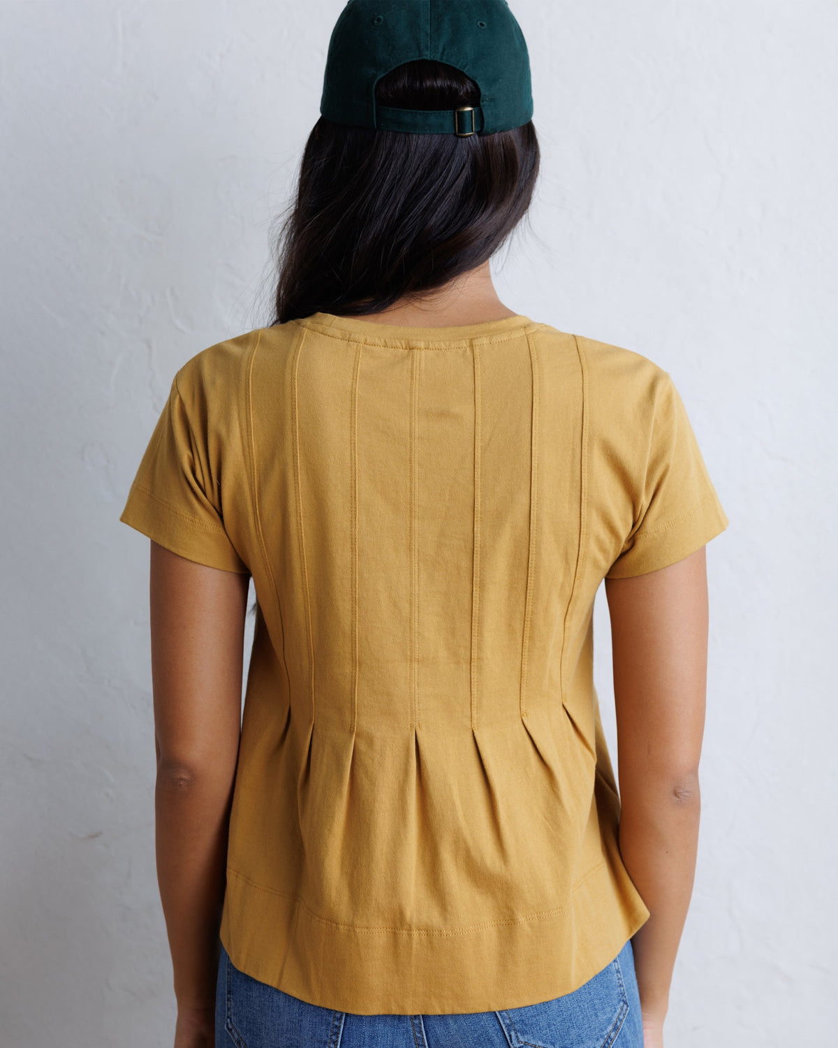 Downeast Portland peplum top in soft fabric with ruffled hem and fitted waist, displayed on a neutral background.