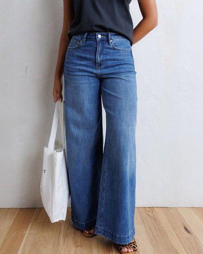 Downeast super high wide leg slouchy denim jeans shown with distressed wash and relaxed fit.