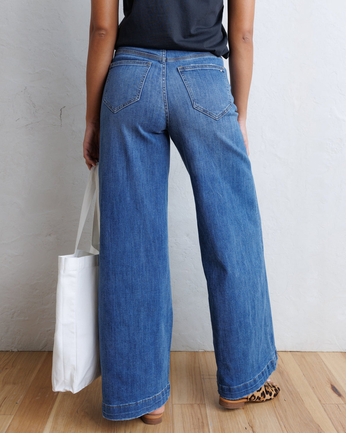 Downeast super high wide-leg slouchy denim jeans displayed on a model, showcasing relaxed fit and washed blue color.