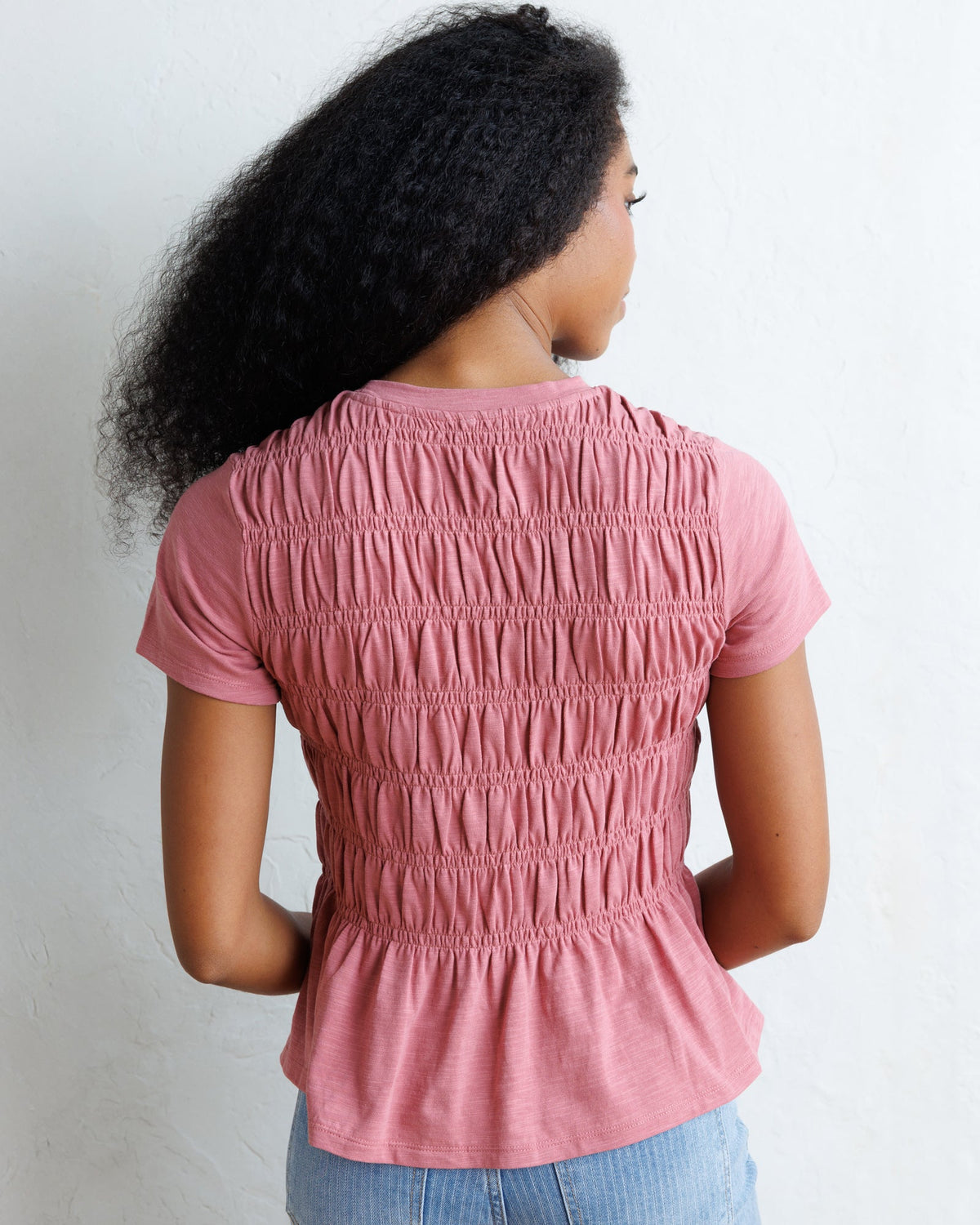 Downeast smocked tee top in soft fabric with a fitted, gathered design, featuring a casual and stylish look.